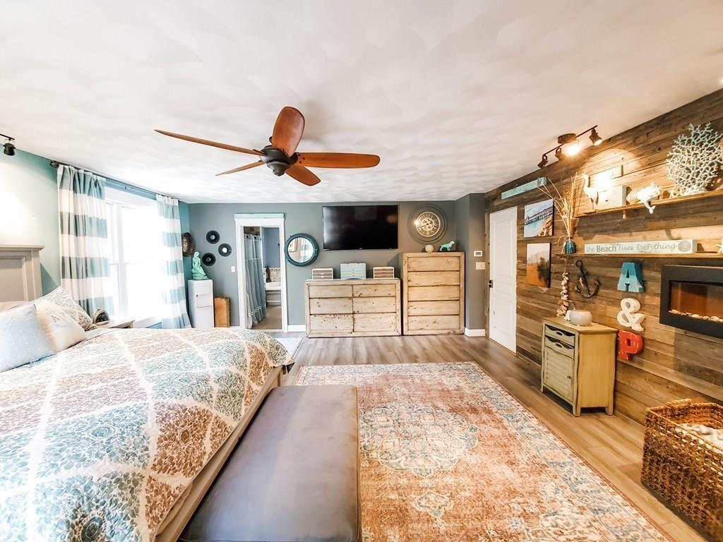 53 Batchelder Road Reading, MA 01867 - Photo 29 of 42 a spacious bedroom with a large bed and a large window