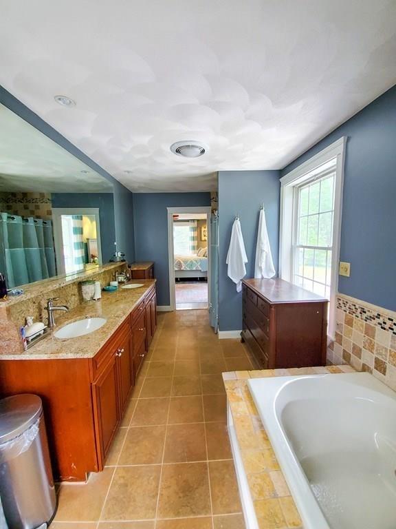53 Batchelder Road Reading, MA 01867 - Photo 31 of 42 a large spacious bathroom with a large tub and sink