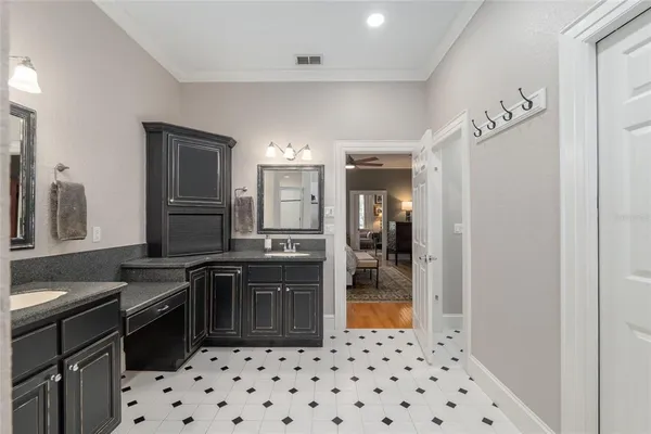 a kitchen with granite countertop a refrigerator and a sink