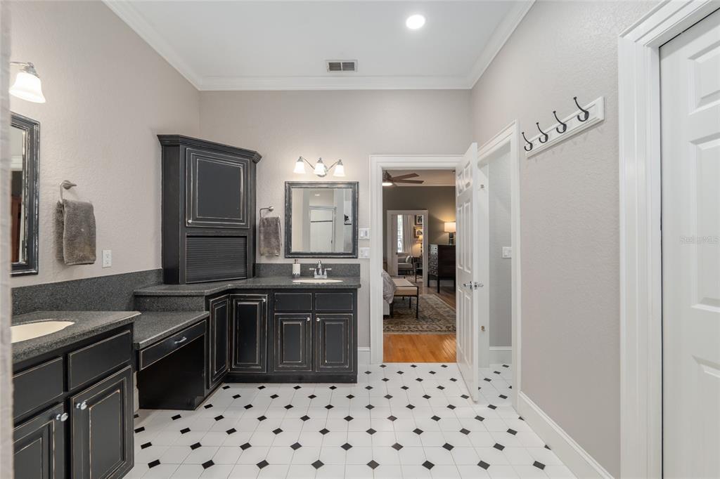 1107 Southeast 9th Avenue Ocala, FL 34471 - Photo 11 of 25 a kitchen with granite countertop a refrigerator and a sink