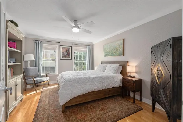 a bedroom with a bed couch and a window