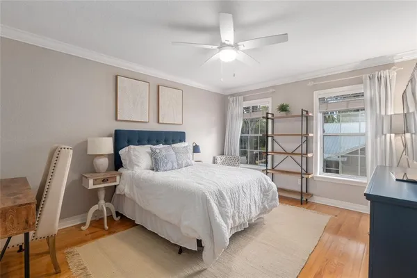 a bedroom with a large bed and a window