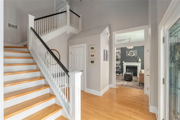 a view of a hallway with wooden floor and entryway