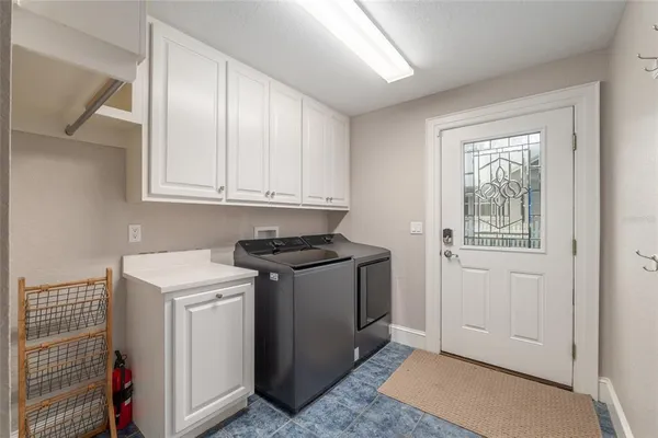 a utility room with sink dryer and washer