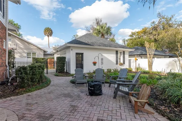 a view of a house with backyard sitting area and garden