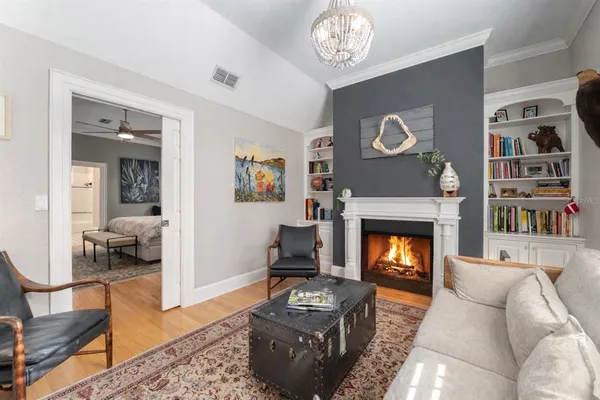 a living room with furniture a fireplace and a flat screen tv