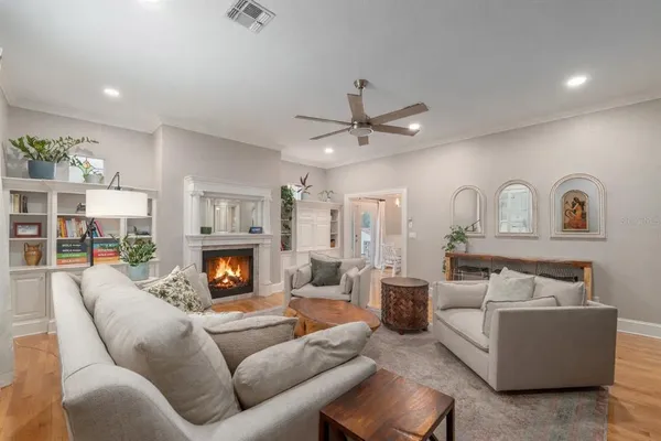 a living room with furniture fireplace and chandelier