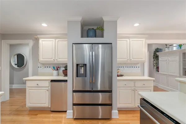 a kitchen with a refrigerator and a sink