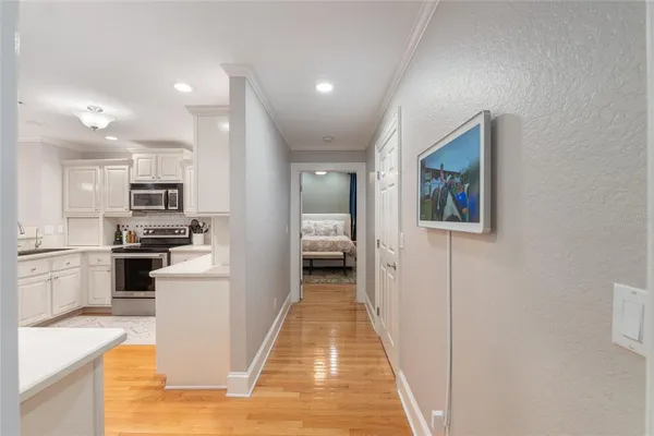 a view of a kitchen with sink and stainless steel appliances