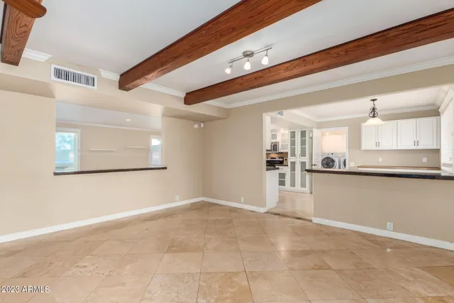 a kitchen that has a lot of cabinets and wooden floor