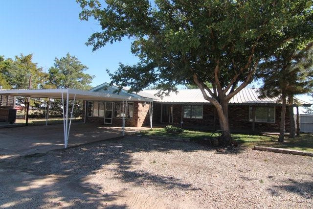 771 U.S. Highway 62 Ralls, TX 79357 - Photo 1 of 10 a view of a grey house with a yard