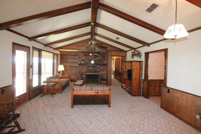 771 U.S. Highway 62 Ralls, TX 79357 - Photo 3 of 10 a living room with furniture and a chandelier