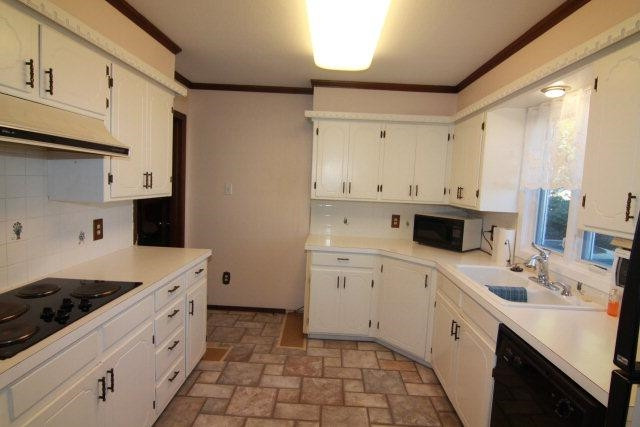 771 U.S. Highway 62 Ralls, TX 79357 - Photo 7 of 10 a large white kitchen with a sink stainless steel appliances and cabinets