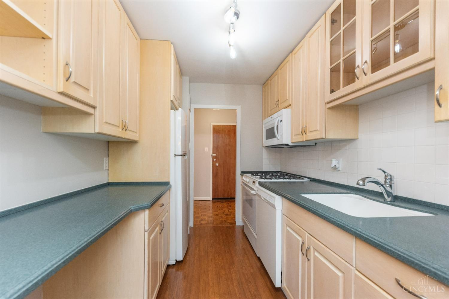 2324 Madison Road, Unit 204 Cincinnati, OH 45208 - Photo 19 of 34 Galley kitchen has plenty of cabinetry for adequate storage. All appliances are less than 4 years old. Stove is less than a year old.