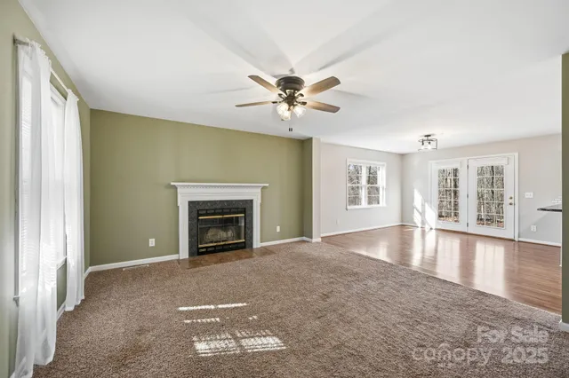 a view of kitchen with refrigerator and wooden floor