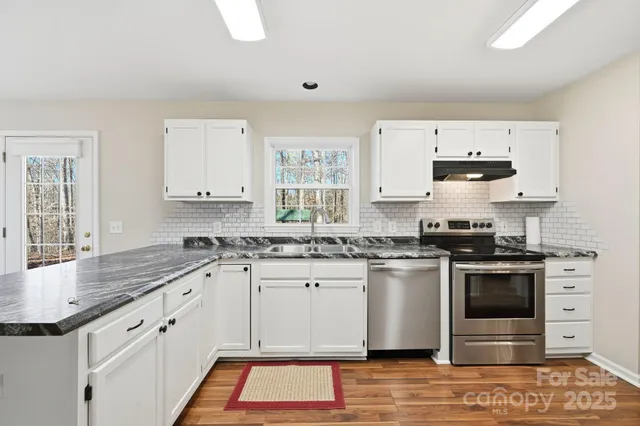 a kitchen with a sink window and cabinets