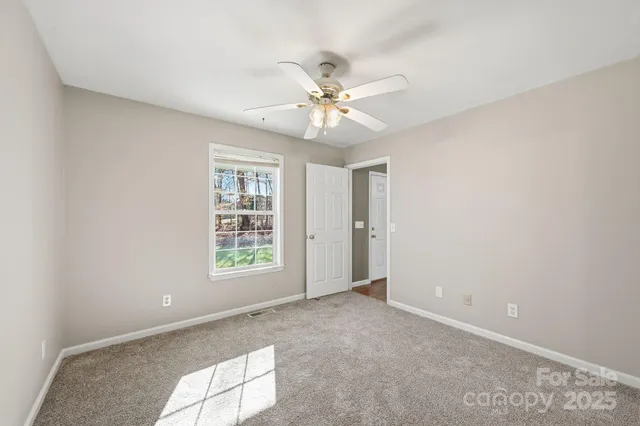 a view of empty room with a fireplace