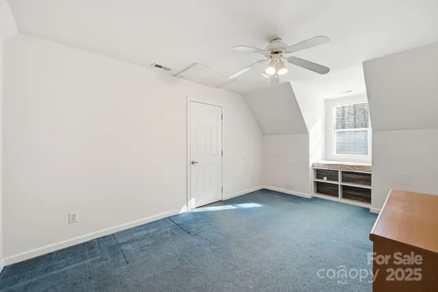 a view of a livingroom with furniture and a ceiling fan