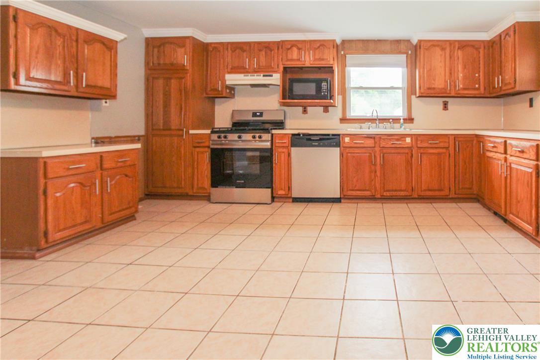 492 Filetown Road Nazareth, PA 18064 - Photo 22 of 30 An inviting culinary space offers a functional layout with wood cabinetry and light-toned tile flooring.