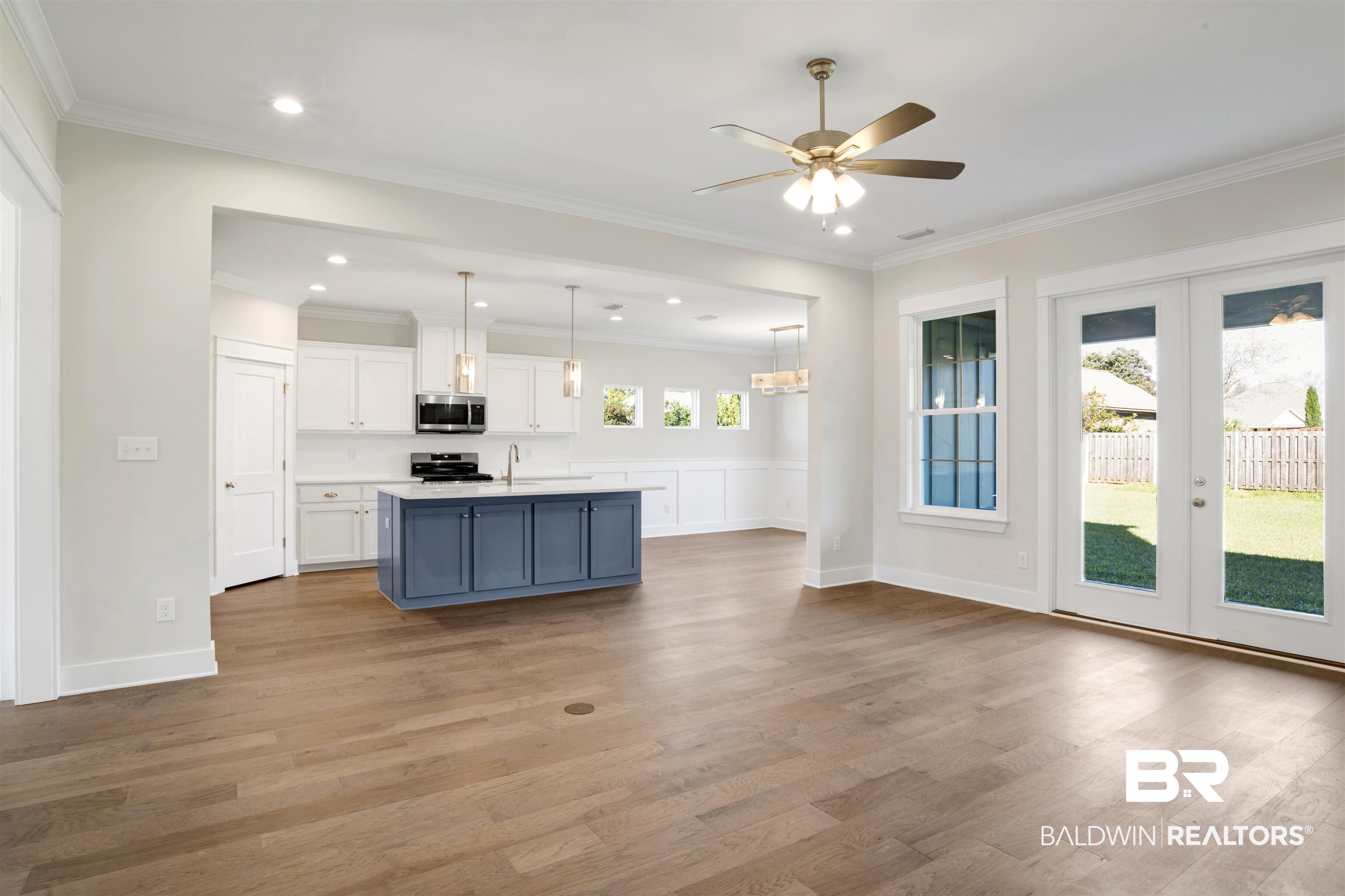9687 Widgeon Court Daphne, AL 36526 - Photo 5 of 40 Kitchen featuring appliances with stainless steel finishes, light wood-type flooring, white cabinetry, and a wealth of natural light
