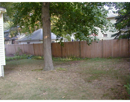 15 Bryn Mawr Road Wellesley, MA 02482 - Photo 4 of 5 a view of a backyard with large trees and wooden fence