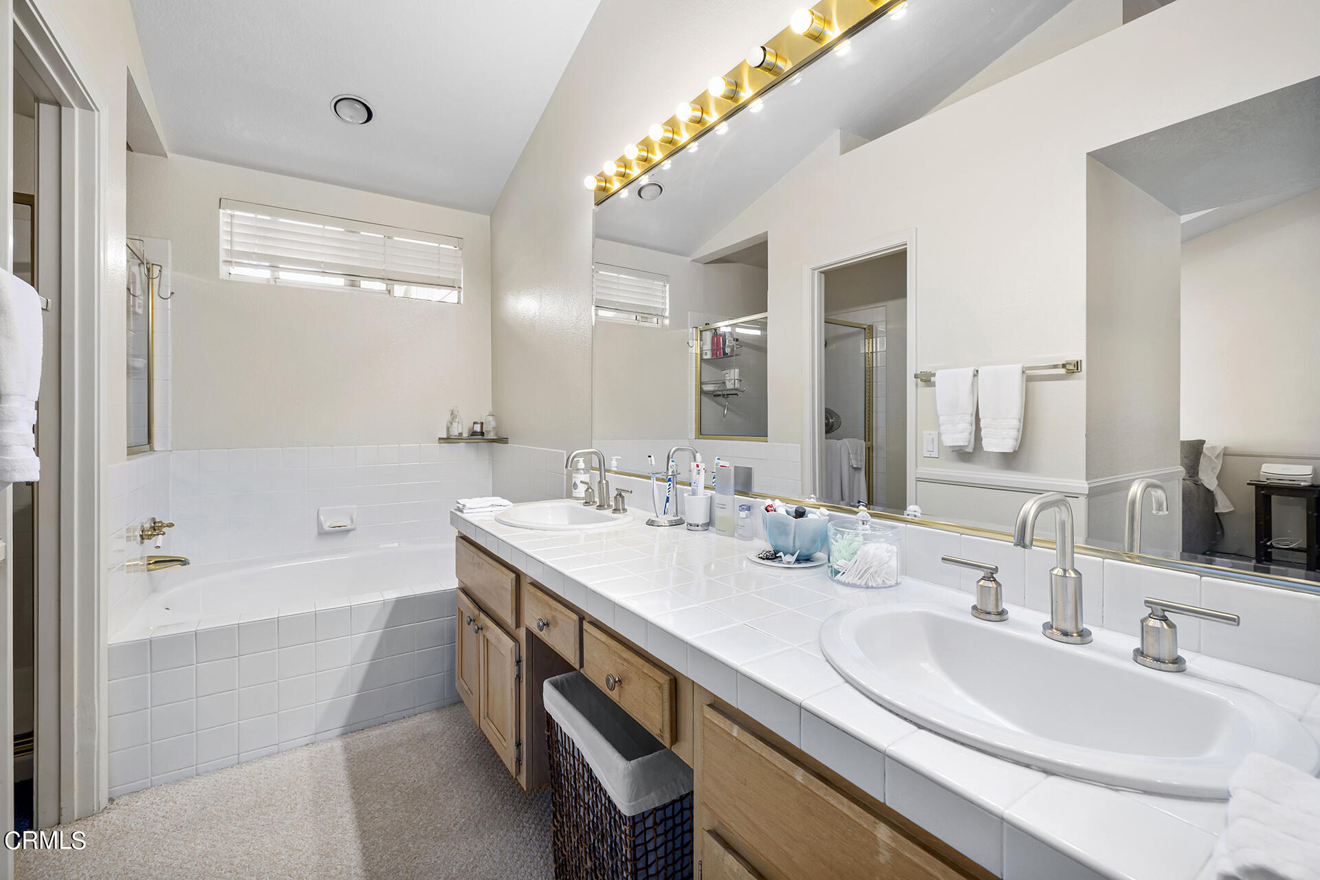 1094 Rocton Drive Pasadena, CA 91107 - Photo 16 of 25 a bathroom with a bathtub double vanity sink and a mirror