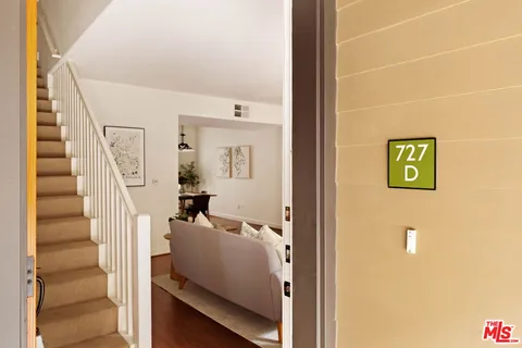 a view of an entryway with wooden floor