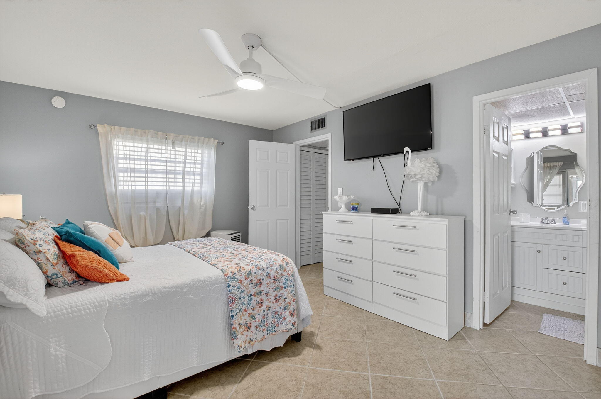 499 Monaco Way, Unit K Delray Beach, FL 33446 - Photo 12 of 33 a bedroom with a bed and flat screen tv