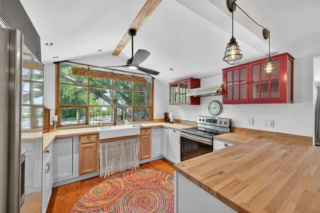 a kitchen with stainless steel appliances granite countertop a stove and a sink