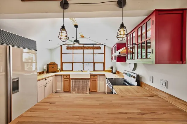 a kitchen with stainless steel appliances granite countertop a stove and cabinets