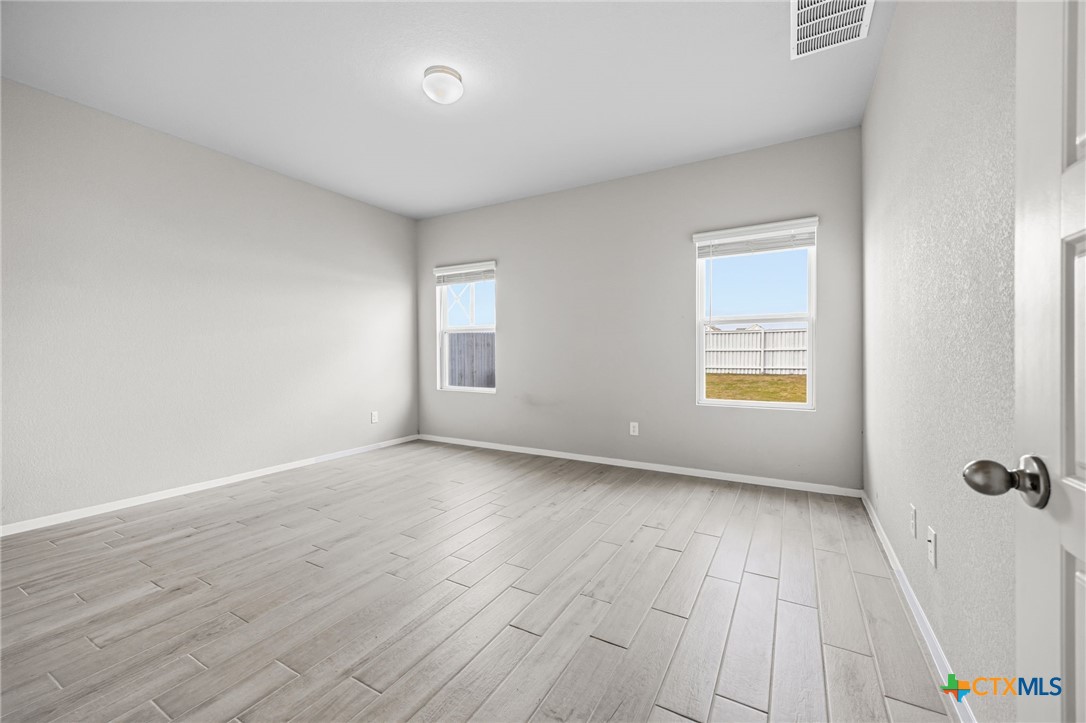 251 Chesterfield Drive Kyle, TX 78640 - Photo 11 of 24 an empty room with windows