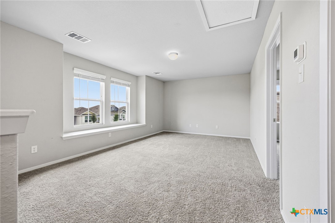 251 Chesterfield Drive Kyle, TX 78640 - Photo 14 of 24 a view of an empty room with a window