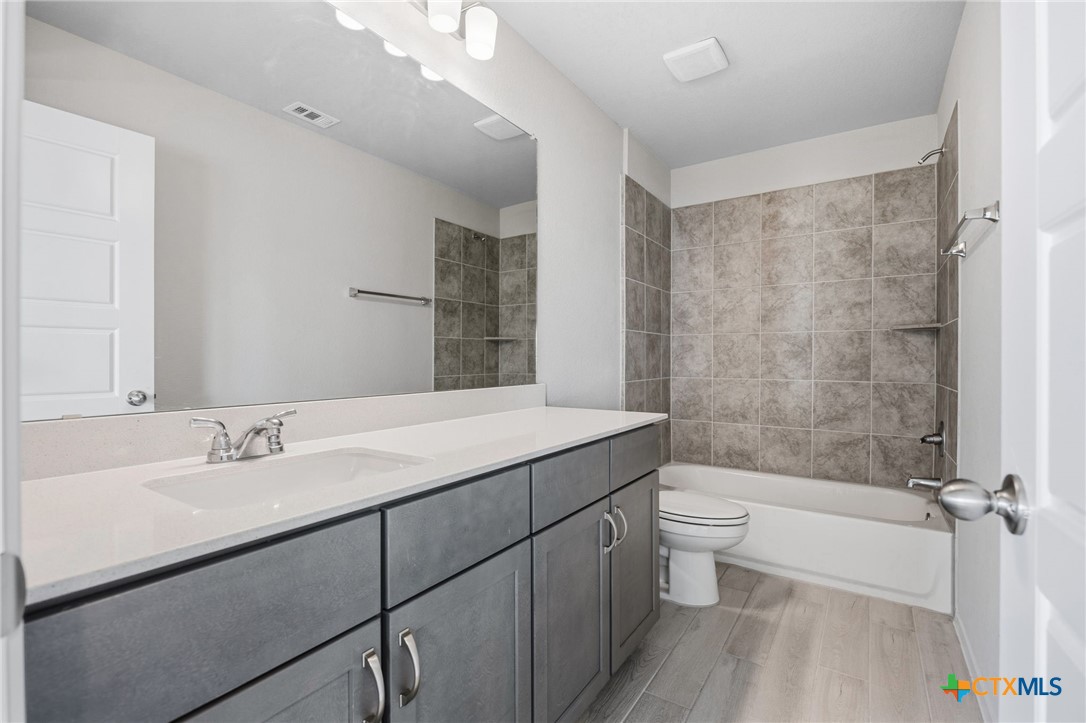 251 Chesterfield Drive Kyle, TX 78640 - Photo 16 of 24 a bathroom with a sink a toilet and shower