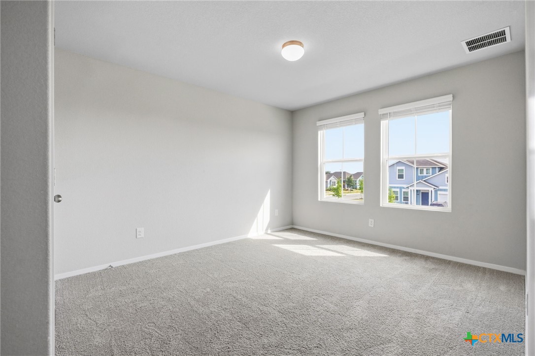 251 Chesterfield Drive Kyle, TX 78640 - Photo 18 of 24 an empty room with windows