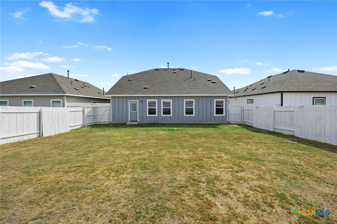251 Chesterfield Drive Kyle, TX 78640 - Photo 19 of 24 a front view of a house with a garden