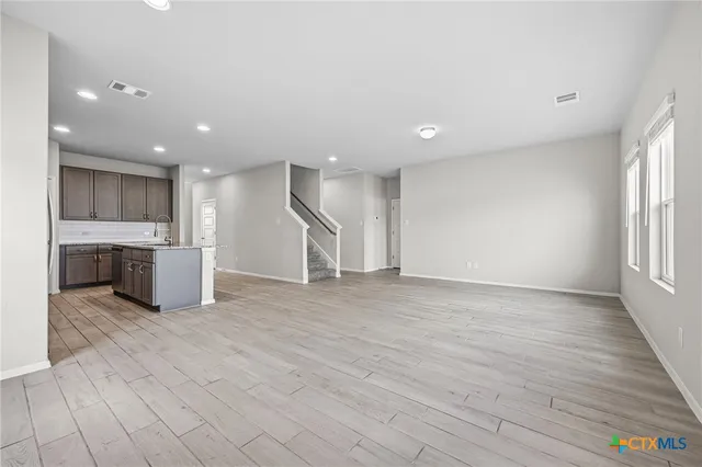 a view of a kitchen with a sink and a window
