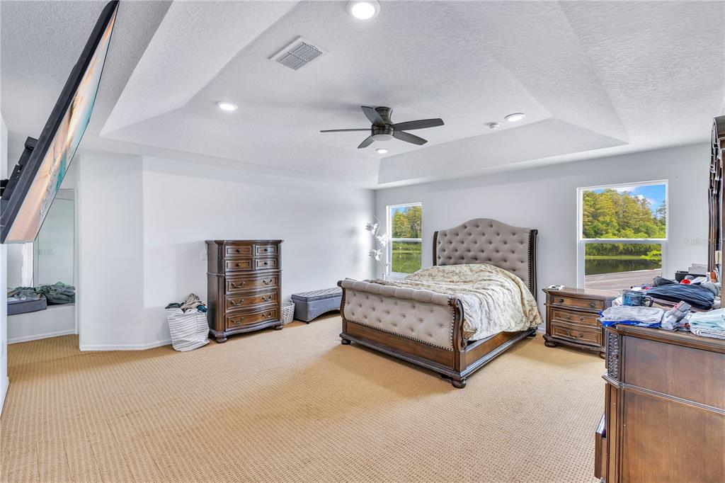 3480 Pawleys Loop North St. Cloud, FL 34769 - Photo 11 of 23 a spacious bedroom with a bed and a couch