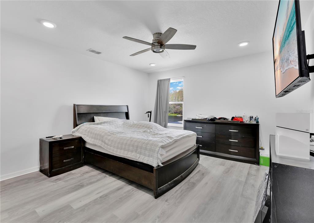 3480 Pawleys Loop North St. Cloud, FL 34769 - Photo 11 of 25 a bedroom with a bed and cabinets