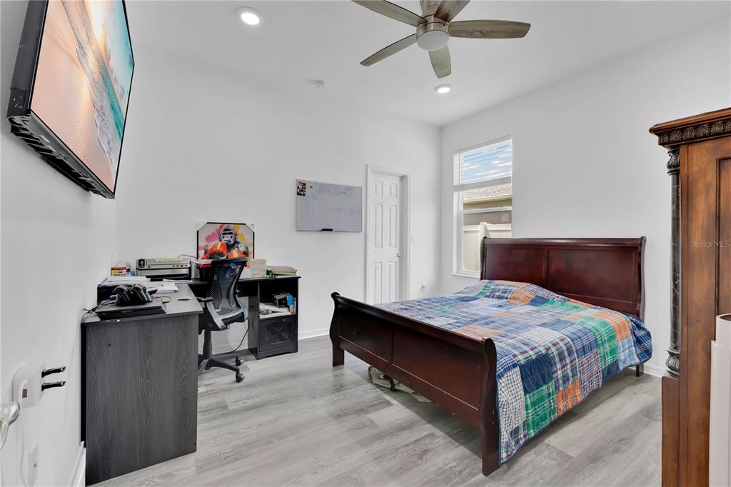 3480 Pawleys Loop North St. Cloud, FL 34769 - Photo 14 of 25 a bedroom with a bed and a chandelier