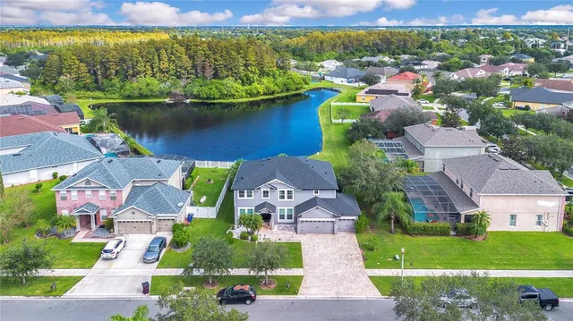 an aerial view of a house with a lake view