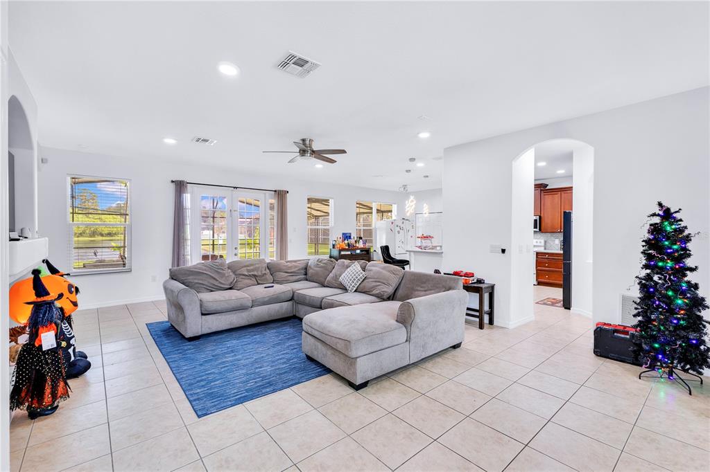 3480 Pawleys Loop North St. Cloud, FL 34769 - Photo 2 of 23 a living room with furniture and flowers