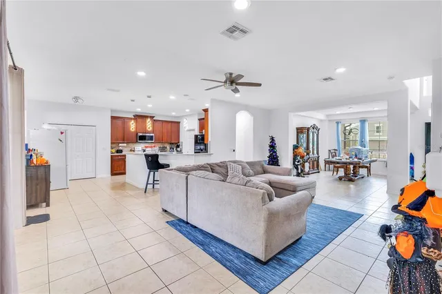 a living room with furniture and kitchen view