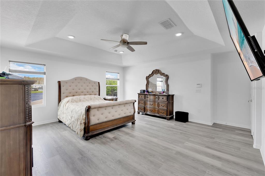 3480 Pawleys Loop North St. Cloud, FL 34769 - Photo 8 of 25 a bedroom with a bed chandelier and a window
