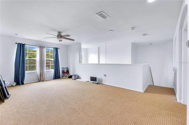 a large white bed in a white room