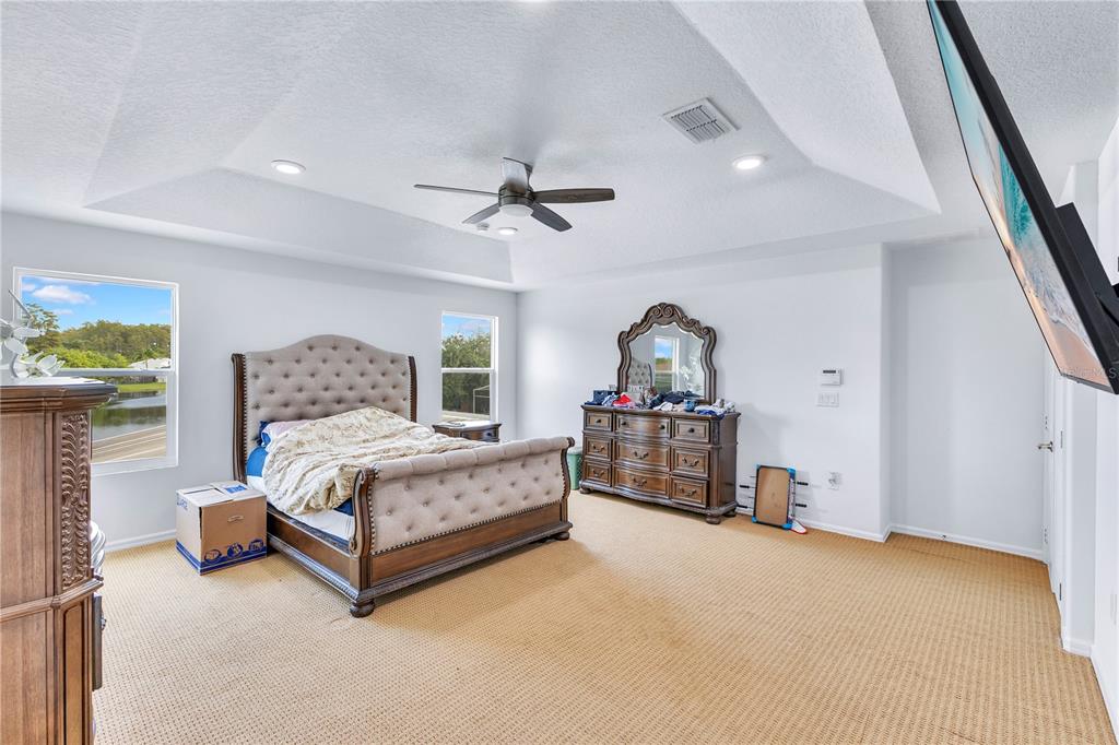 3480 Pawleys Loop North St. Cloud, FL 34769 - Photo 10 of 23 a bedroom with a bed chandelier and window