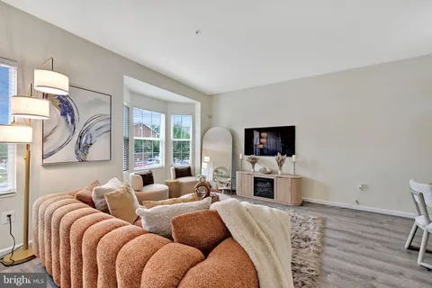 a living room with furniture fireplace and a flat screen tv