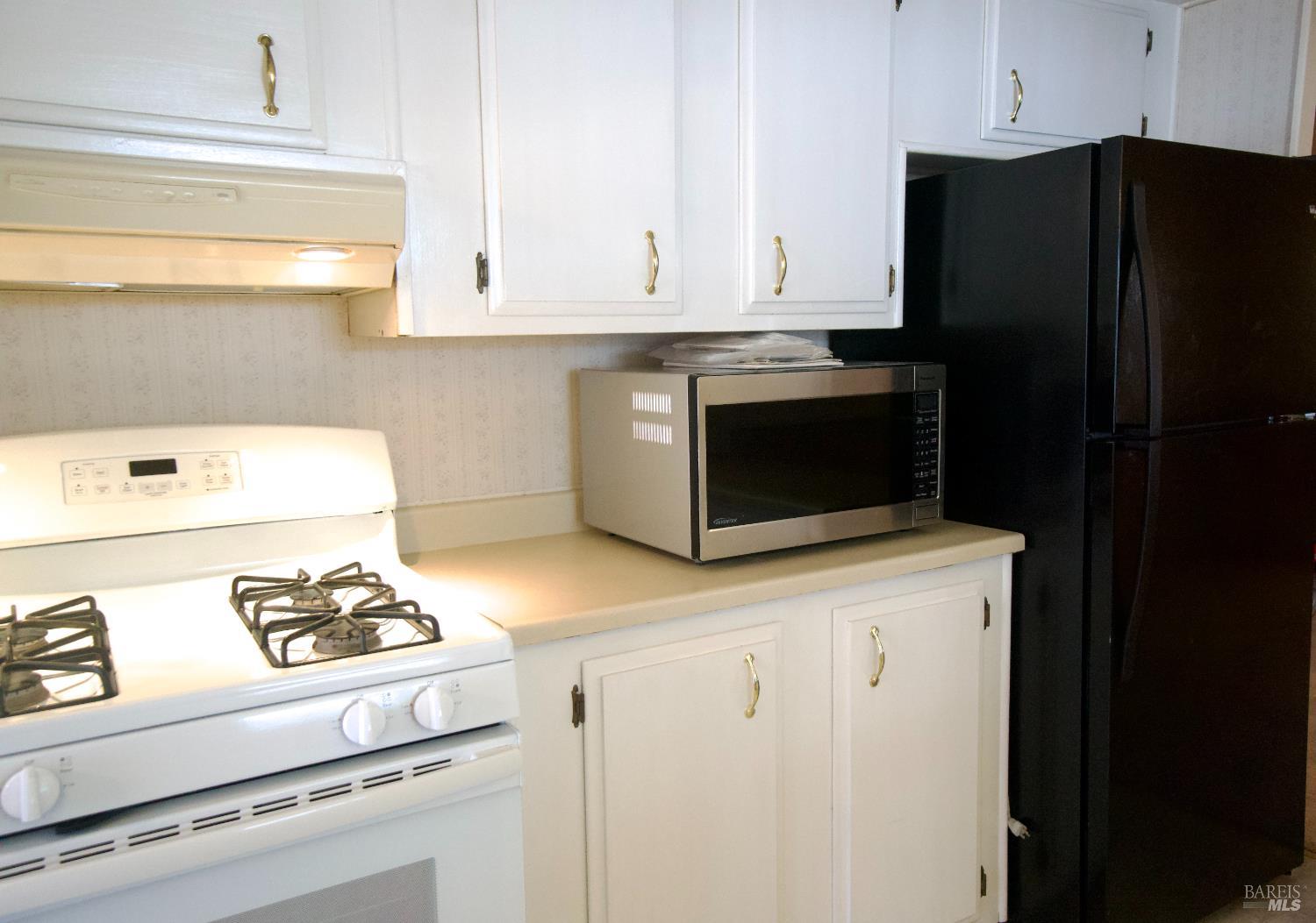 529 Colonial Park Drive Santa Rosa, CA 95403 - Photo 13 of 27 full gas range, microwave on counter and refrigerator