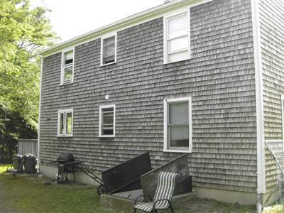 32 Winslows Drive Mashpee, MA 02649 - Photo 5 of 6 a front view of a house with outdoor seating