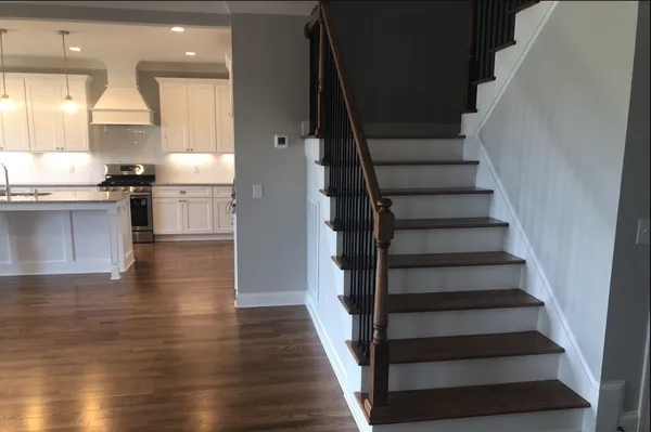 a view of a kitchen with wooden floor and electronic appliances