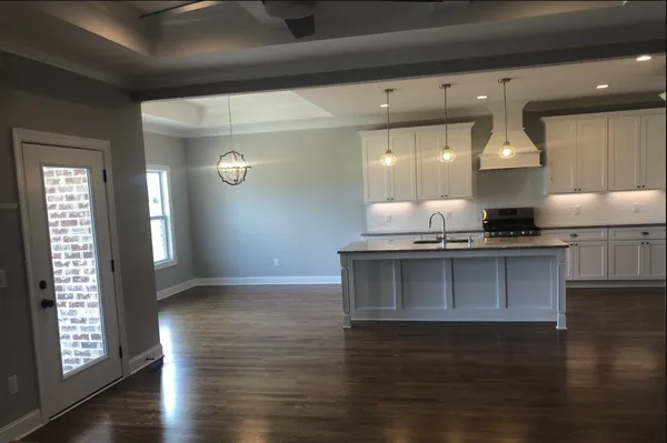 a kitchen with granite countertop a stove and cabinets